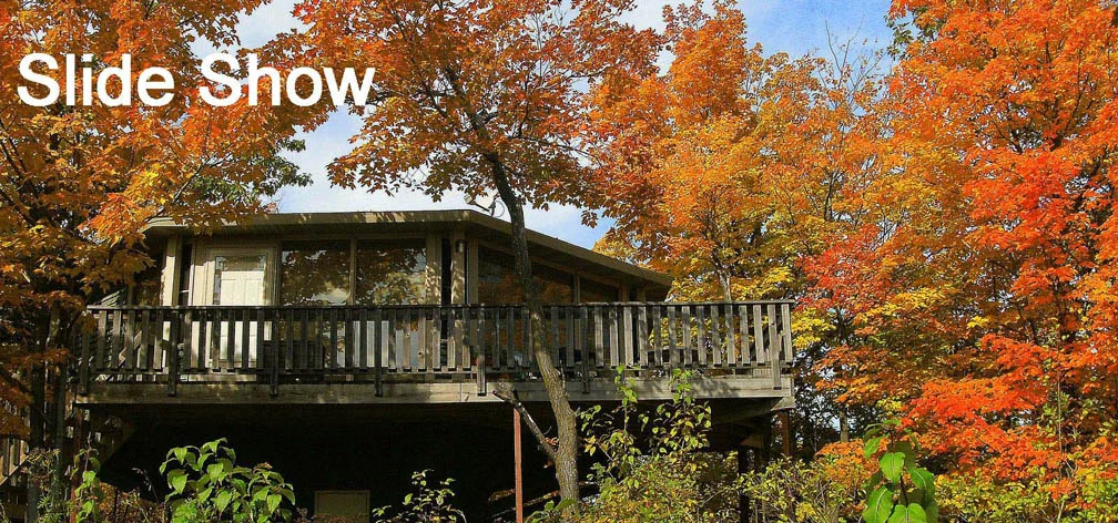 A view of a Mountain Villa surrounded by beautiful autumn leaves. It is a link to a Slide Show
